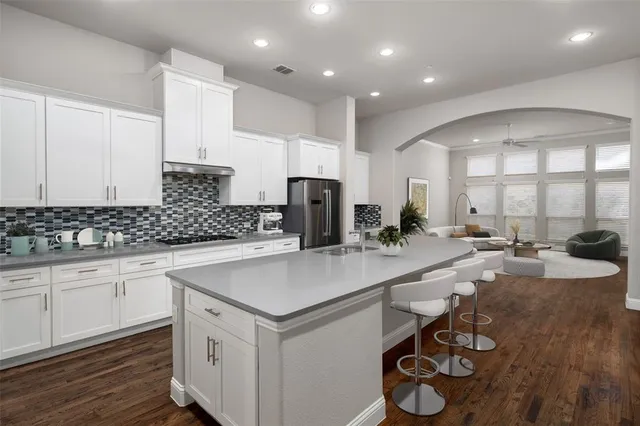 a kitchen with a sink appliances and cabinets