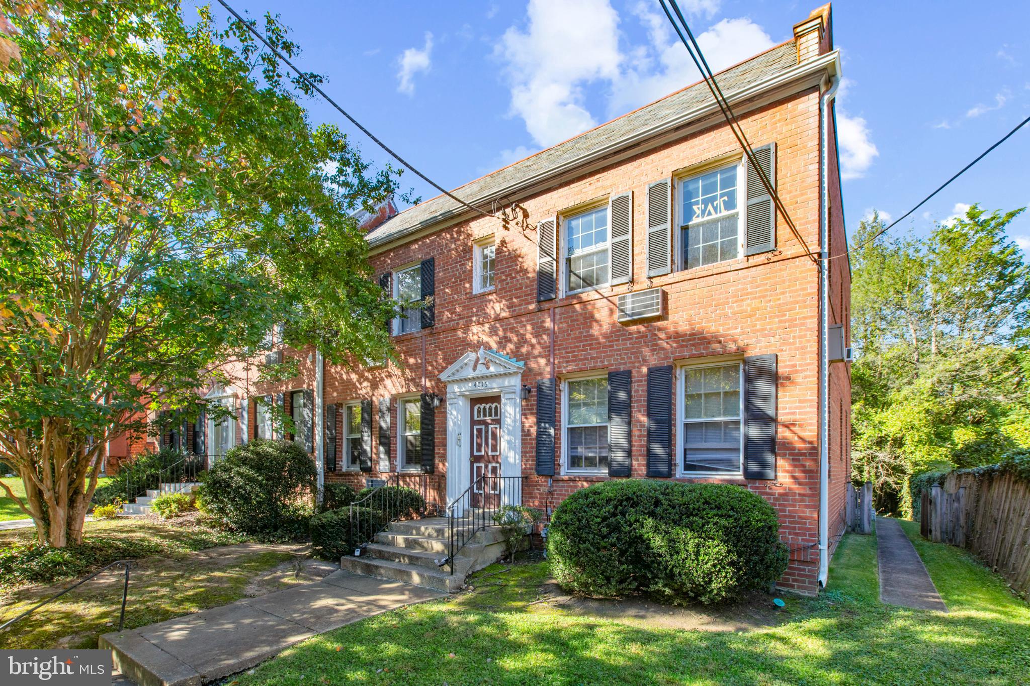 a view of a brick building next to a yard