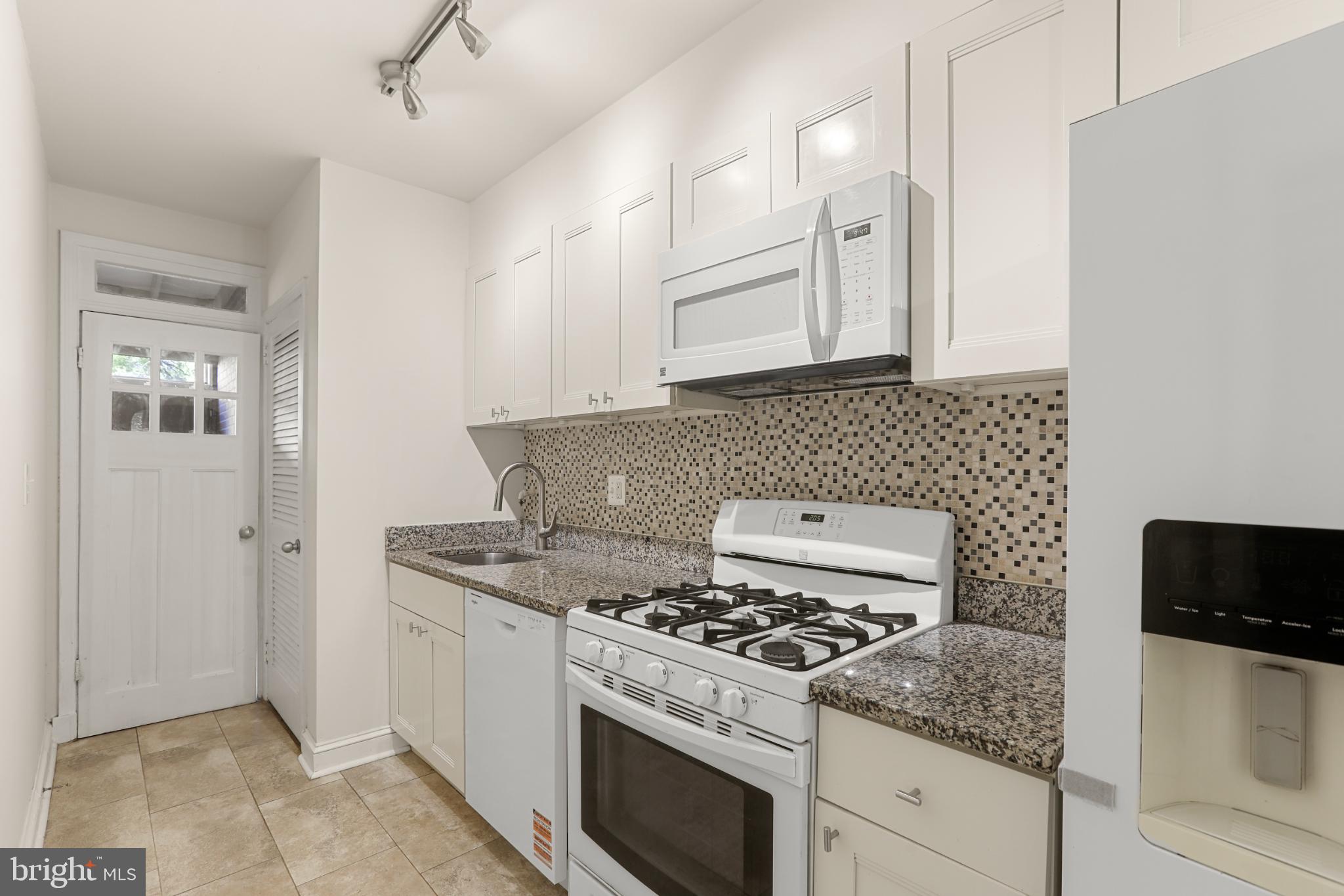 4016 47th Street Northwest, Unit 2 Washington, DC 20016 - Photo 11 of 27 a white stove top oven sitting inside of a kitchen