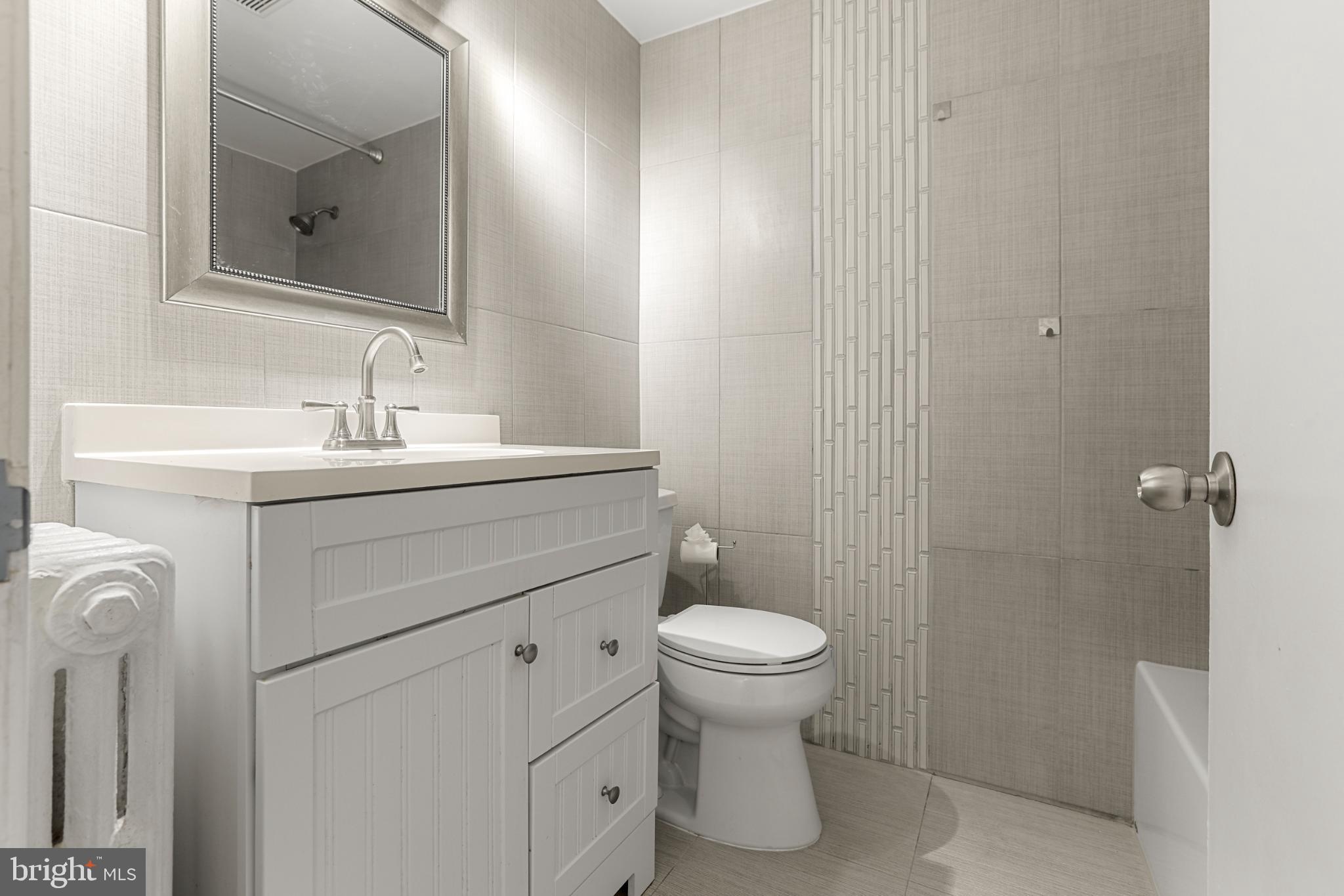 4016 47th Street Northwest, Unit 2 Washington, DC 20016 - Photo 16 of 27 a bathroom with a sink toilet and shower