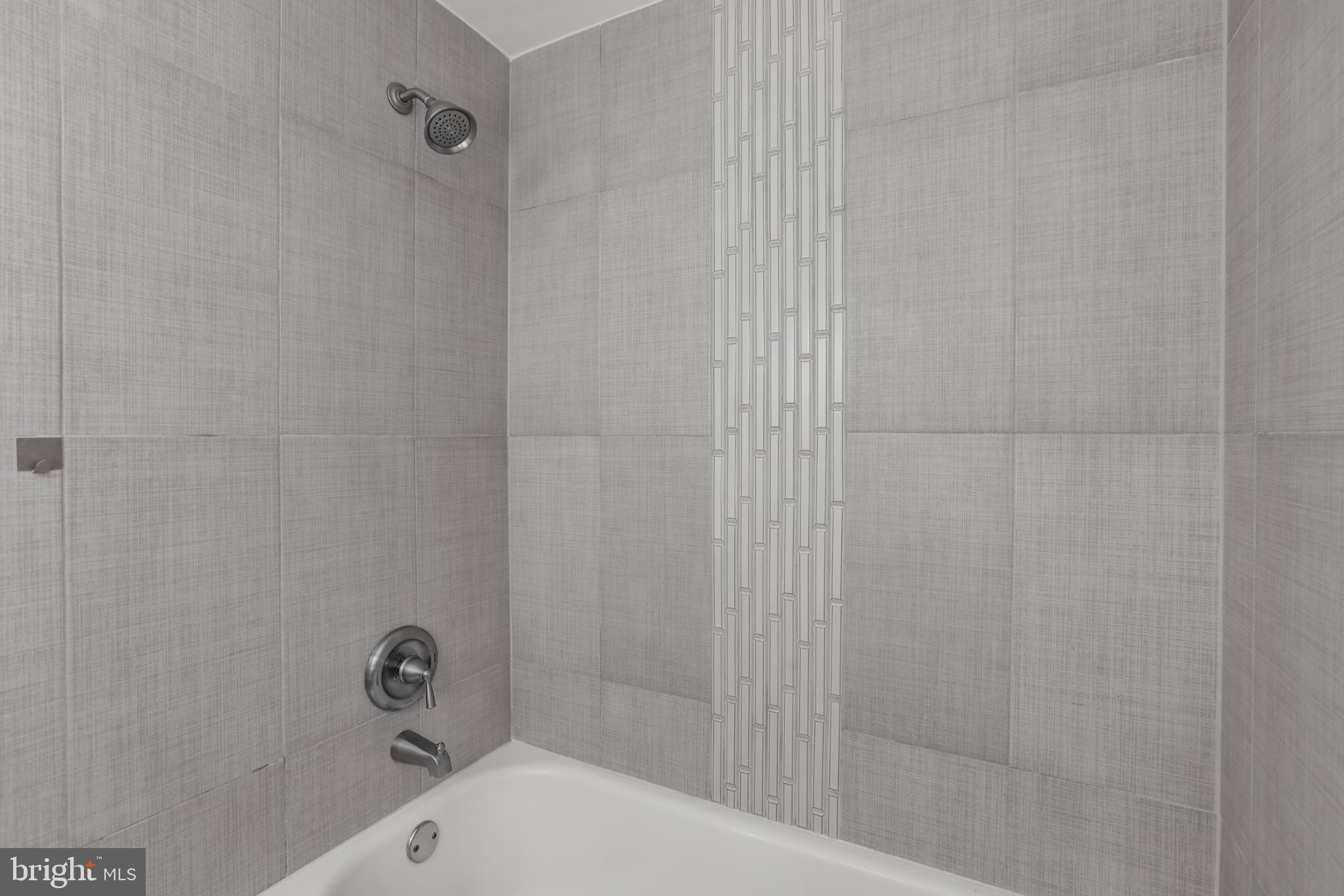 4016 47th Street Northwest, Unit 2 Washington, DC 20016 - Photo 18 of 27 a bathroom with a bathtub and shower