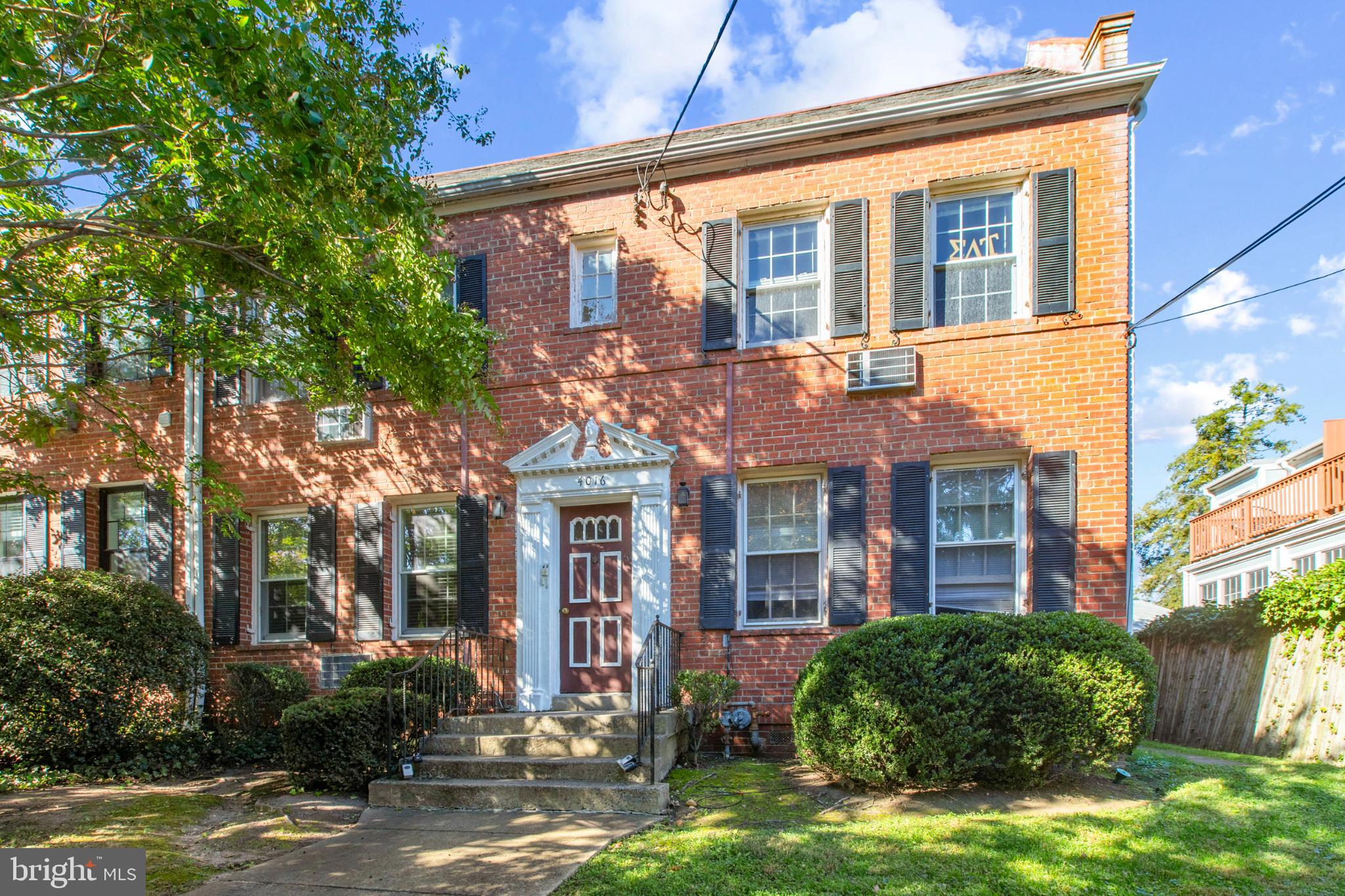 4016 47th Street Northwest, Unit 2 Washington, DC 20016 - Photo 2 of 27 a front view of a house with yard and green space