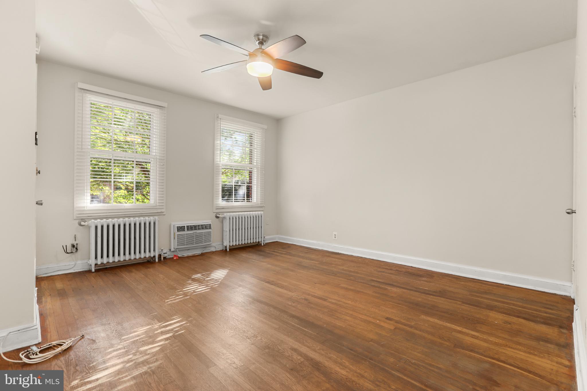 4016 47th Street Northwest, Unit 2 Washington, DC 20016 - Photo 7 of 27 an empty room with wooden floor and windows