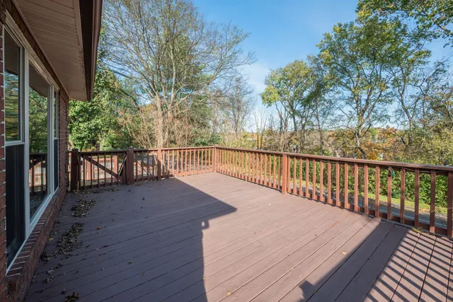 a view of balcony with wooden floor and fence