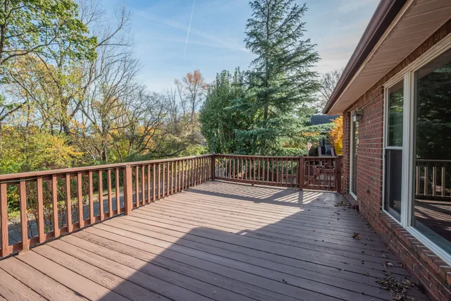 a balcony with wooden floor and fence