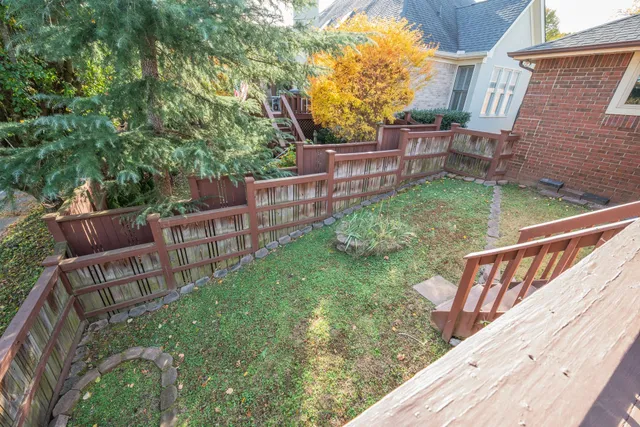 a view of an house with backyard and sitting area