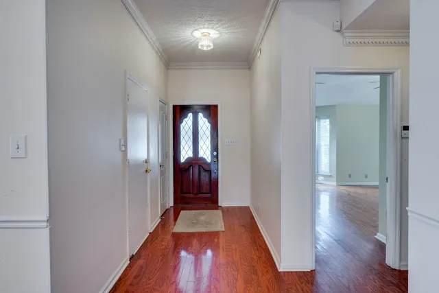 a view of hallway with wooden floor