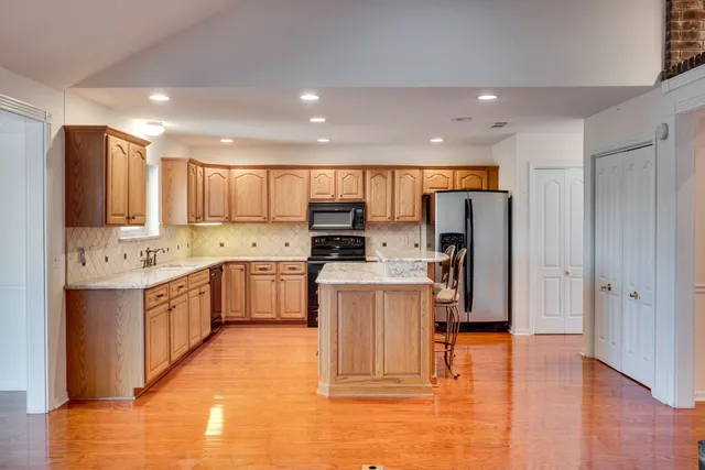a kitchen with stainless steel appliances granite countertop a refrigerator sink and cabinets