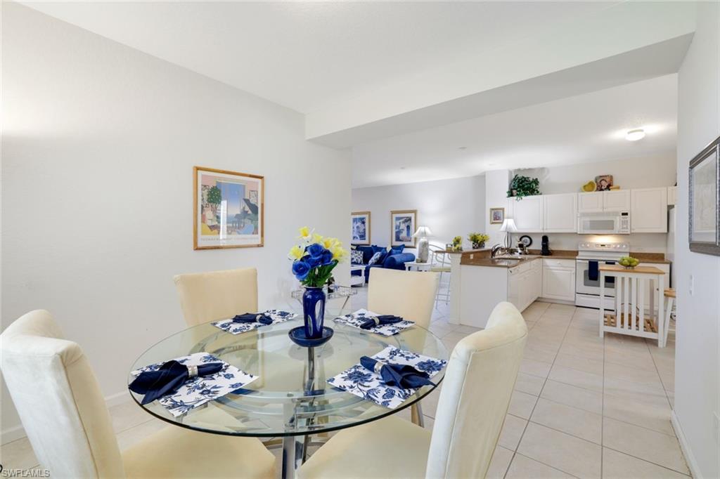 10049 Heather Lane, Unit 101 Naples, FL 34119 - Photo 16 of 28 Dining area featuring light tile patterned floors