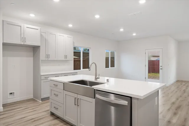 a kitchen with a sink and cabinets