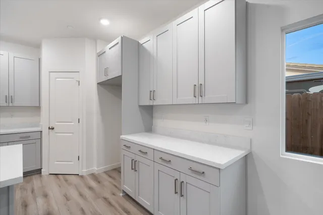 a view of a kitchen with white cabinets