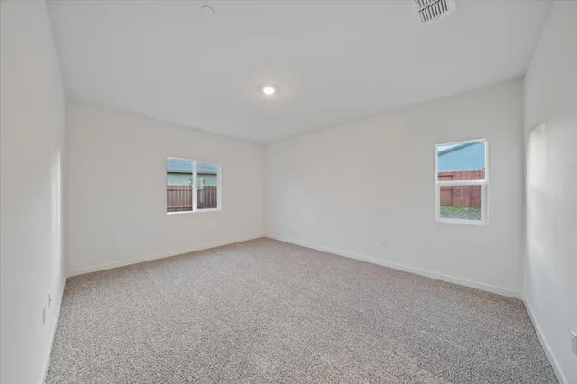 an empty room with a empty space and windows