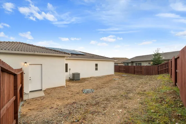 a white house that has a tree in front of it