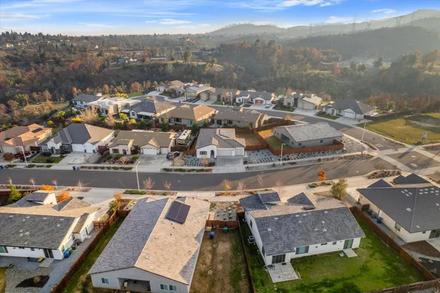 an aerial view of residential houses with outdoor space