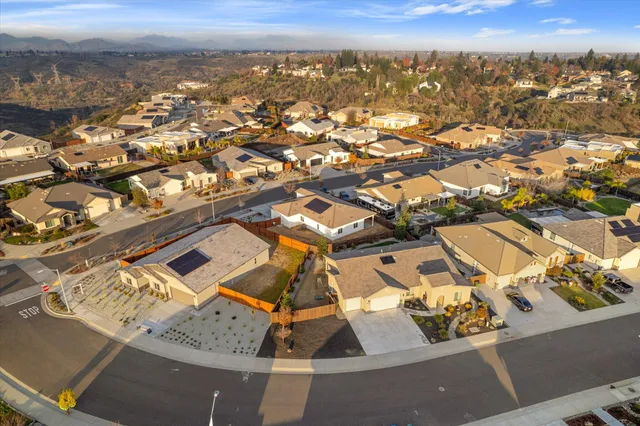 an aerial view of a residential houses with city view