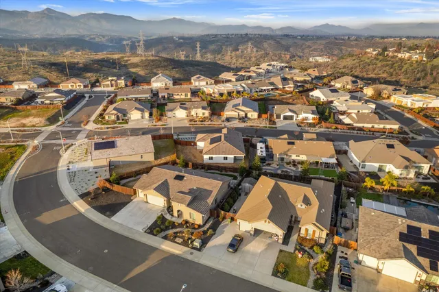 an aerial view of residential building with parking