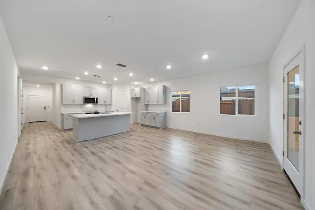 a view of kitchen and kitchen with wooden floor
