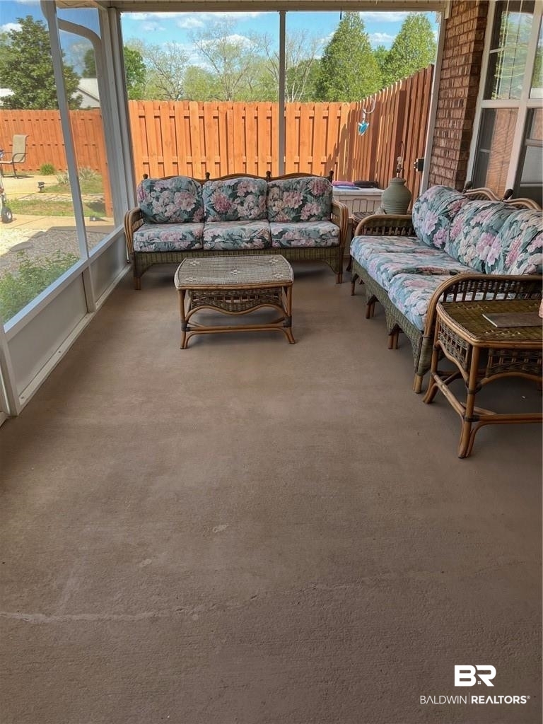 16311 Old Brady Road Bay Minette, AL 36507 - Photo 21 of 38 Screened-in porch featuring a concrete floor, brick exterior wall, and a full privacy fence
