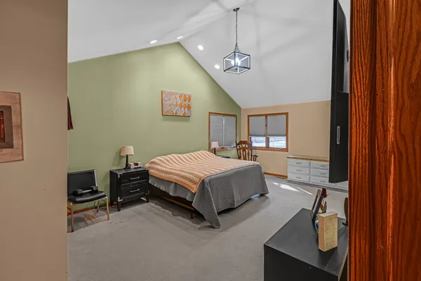 a bedroom with a bed dresser and a window