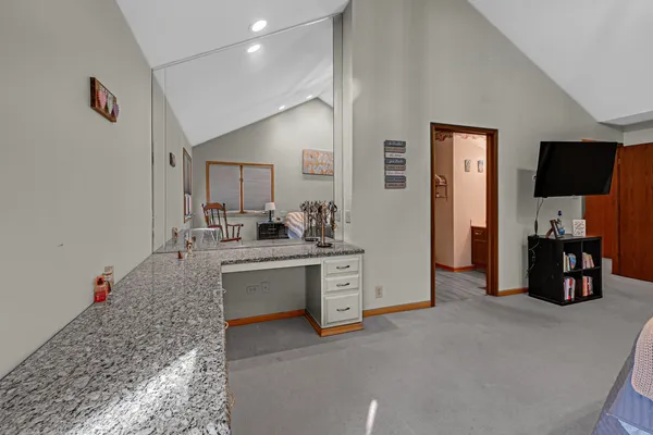 a kitchen with white cabinets and sink