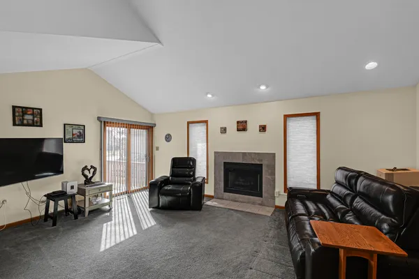 a living room with furniture a fireplace and a flat screen tv