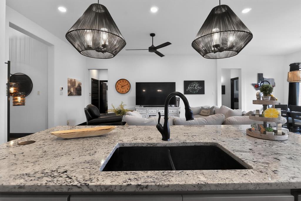 1740 Reverie Road Burleson, TX 76028 - Photo 25 of 37 a kitchen with granite countertop a sink and a stove