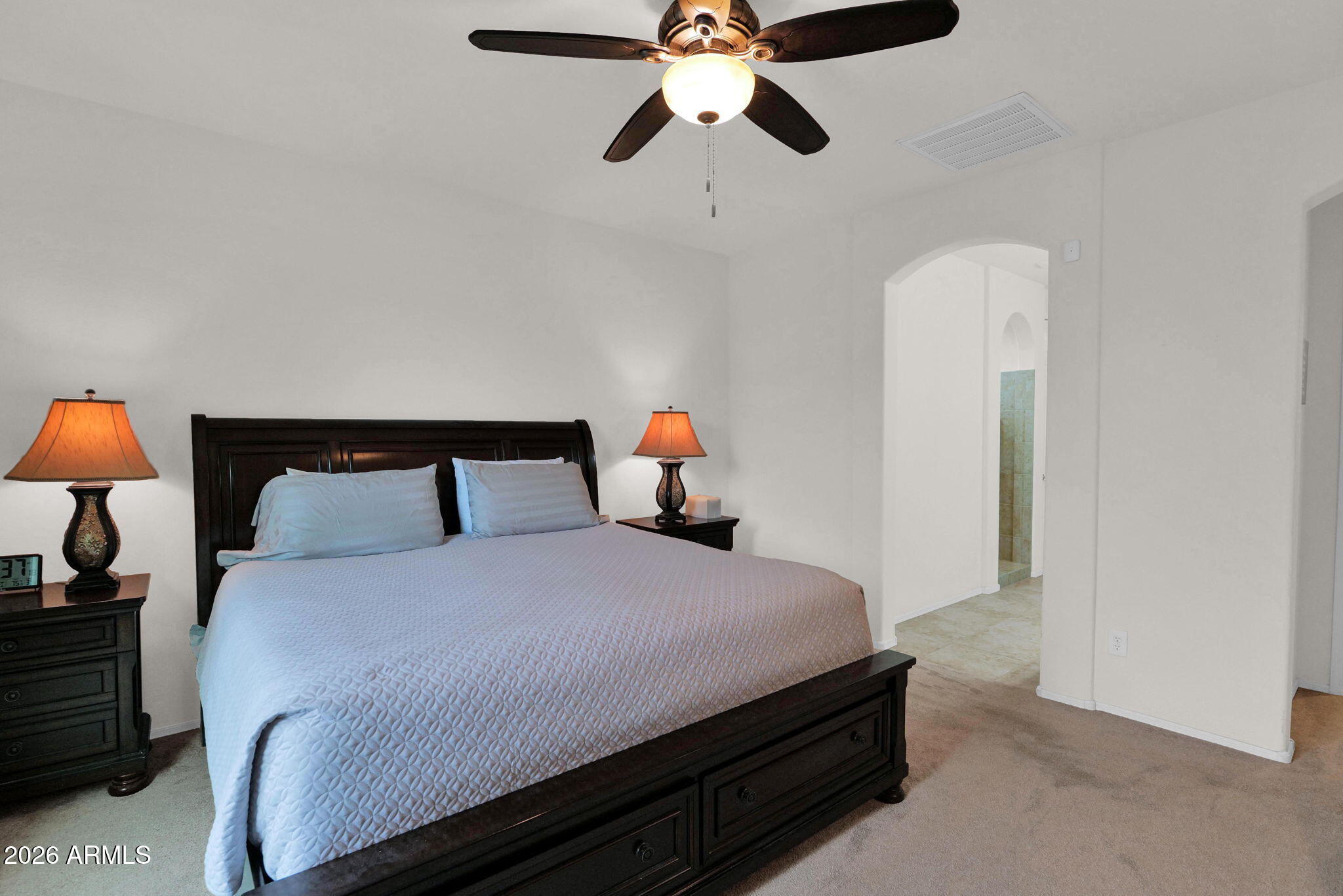 7438 West Noble Prairie Way Florence, AZ 85132 - Photo 16 of 38 a bedroom with a bed and lamp