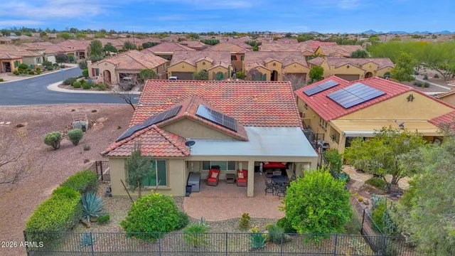 an aerial view of a house with a yard and lake view