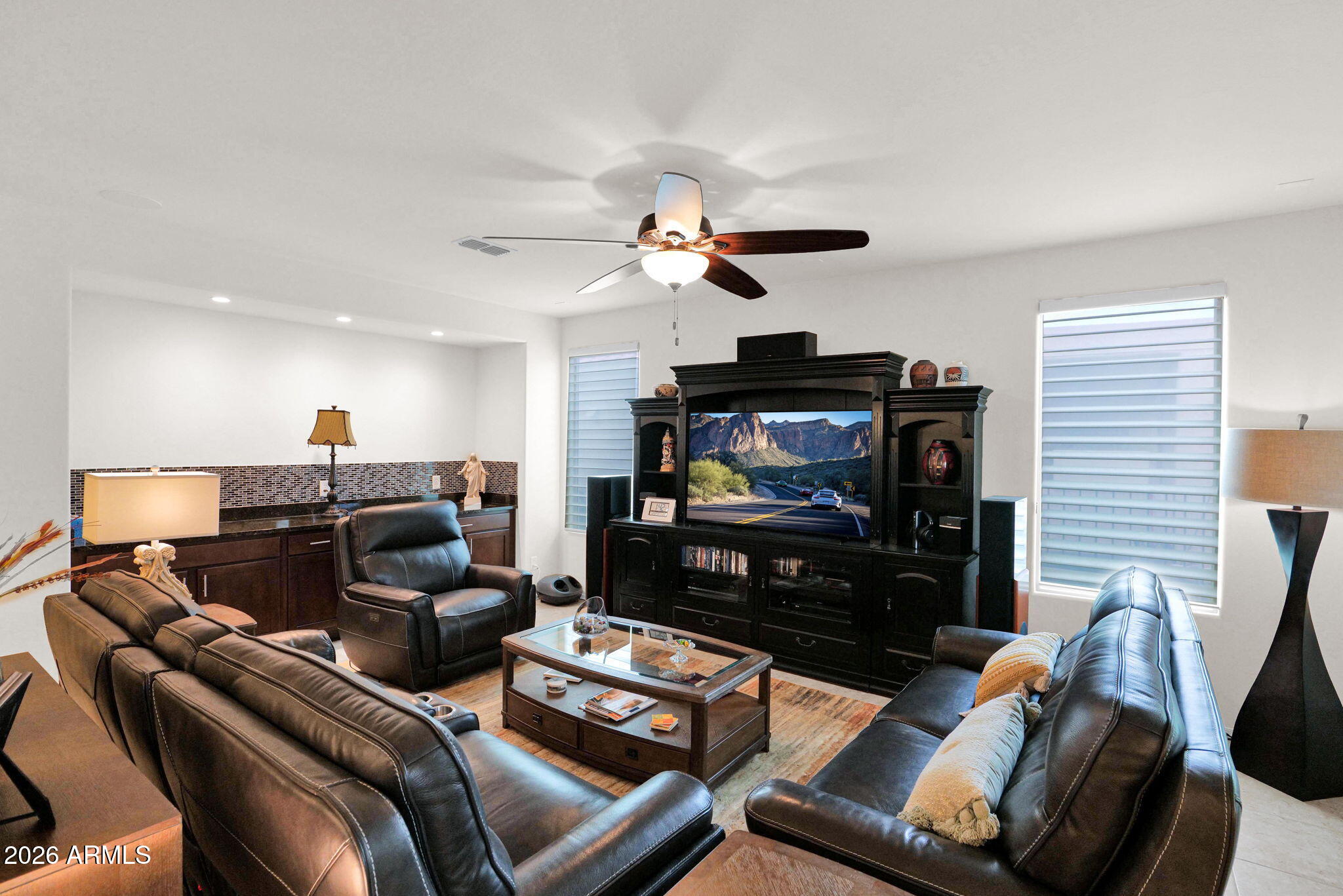 7438 West Noble Prairie Way Florence, AZ 85132 - Photo 28 of 38 a living room with furniture a ceiling fan and a flat screen tv