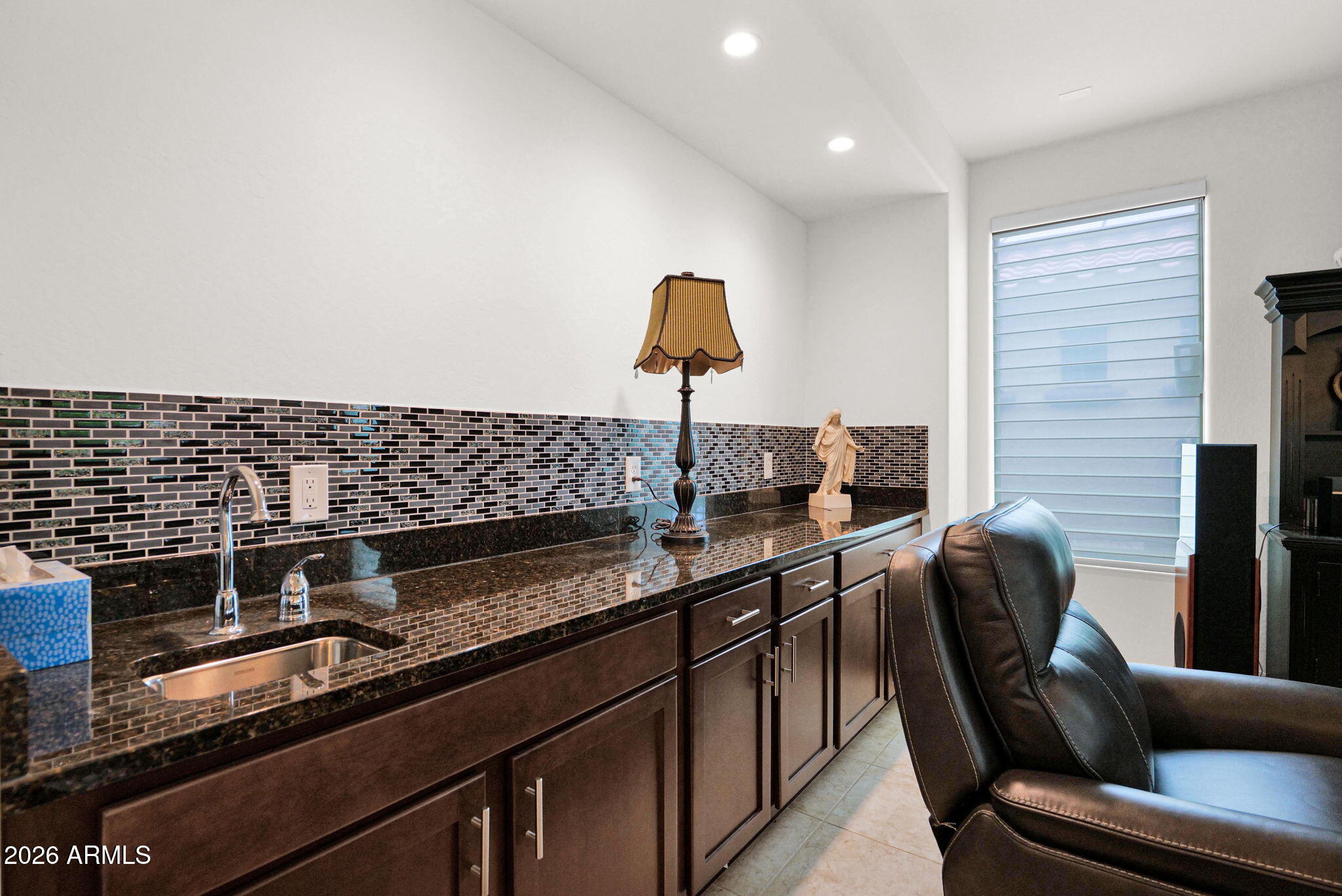 7438 West Noble Prairie Way Florence, AZ 85132 - Photo 29 of 38 a kitchen with stainless steel appliances granite countertop a sink and a stove