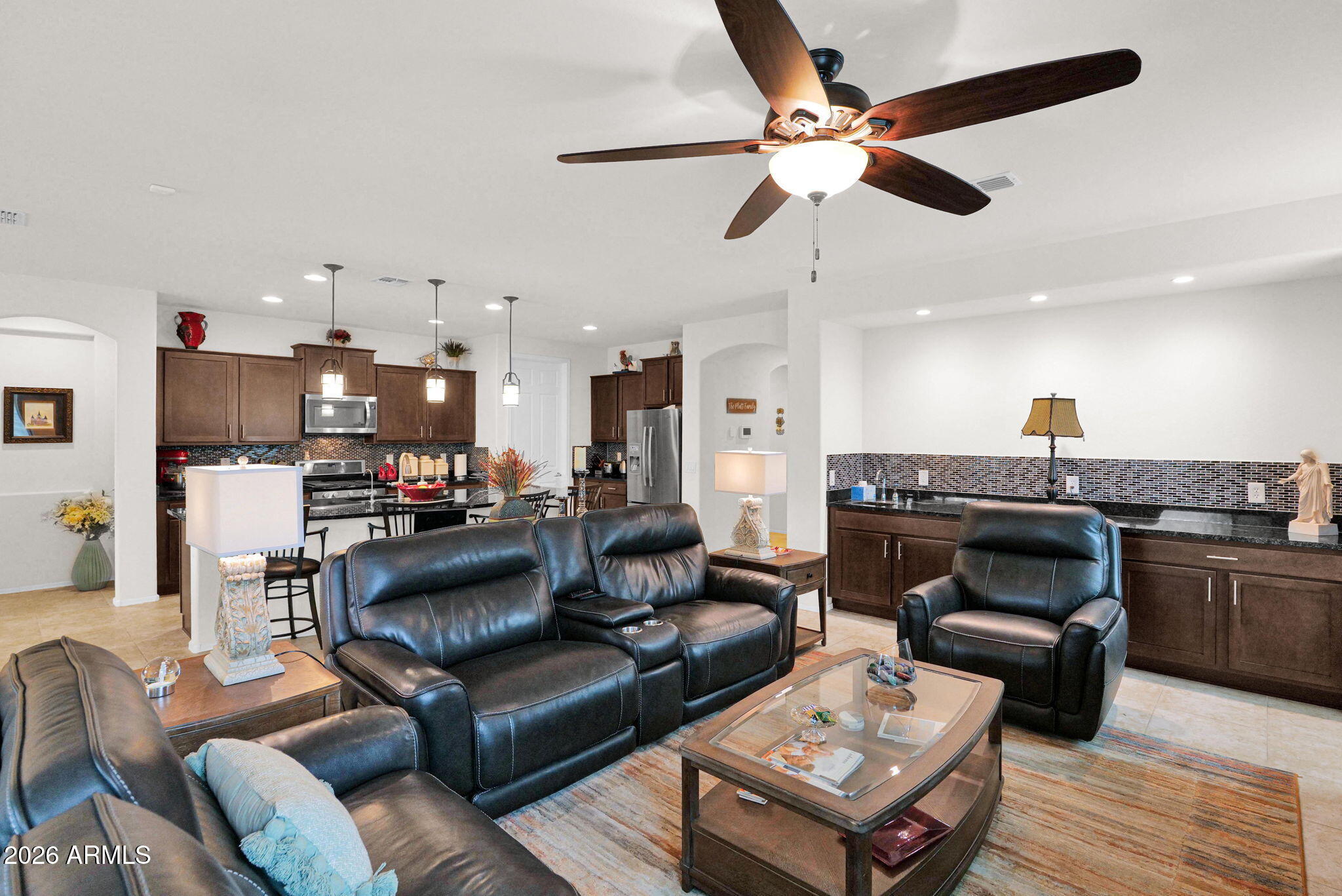 7438 West Noble Prairie Way Florence, AZ 85132 - Photo 31 of 38 a living room with furniture kitchen view and a wooden floor