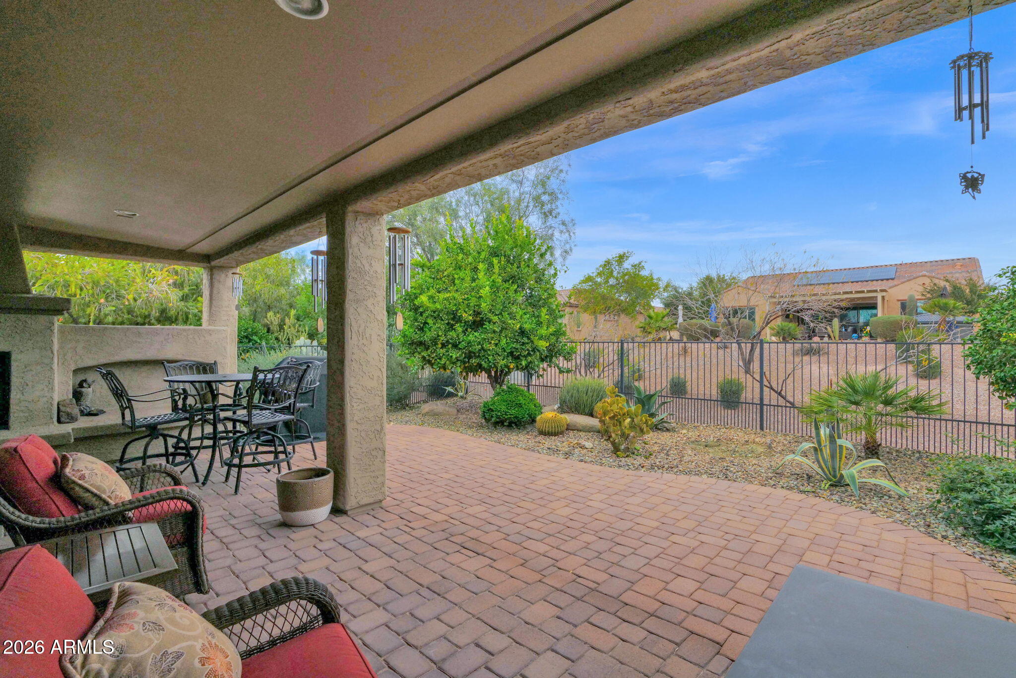 7438 West Noble Prairie Way Florence, AZ 85132 - Photo 35 of 38 a view of a patio with a table chairs and a backyard