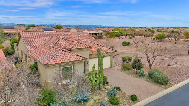 an aerial view of multiple houses with a yard