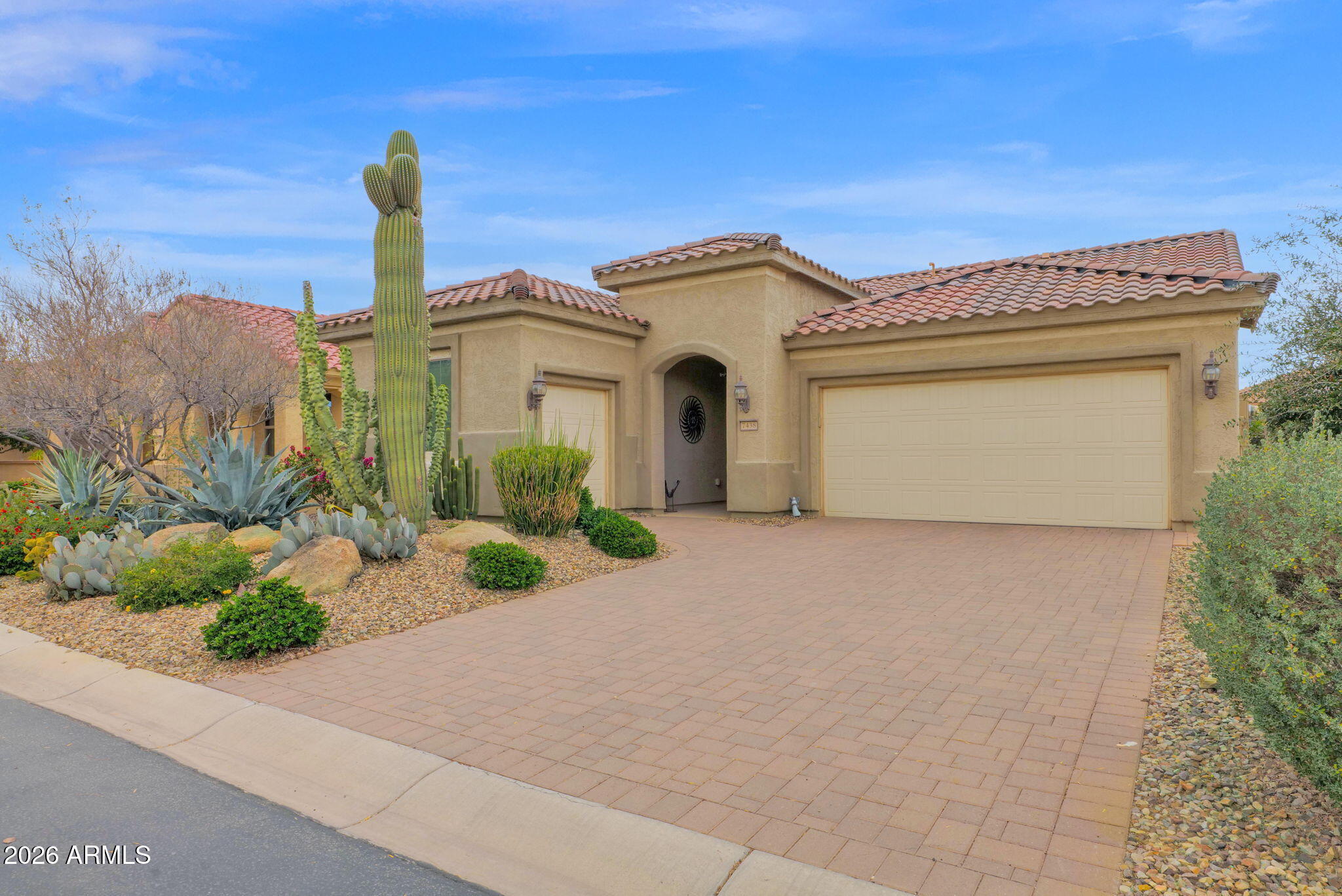 7438 West Noble Prairie Way Florence, AZ 85132 - Photo 9 of 38 a front view of a house with a garden