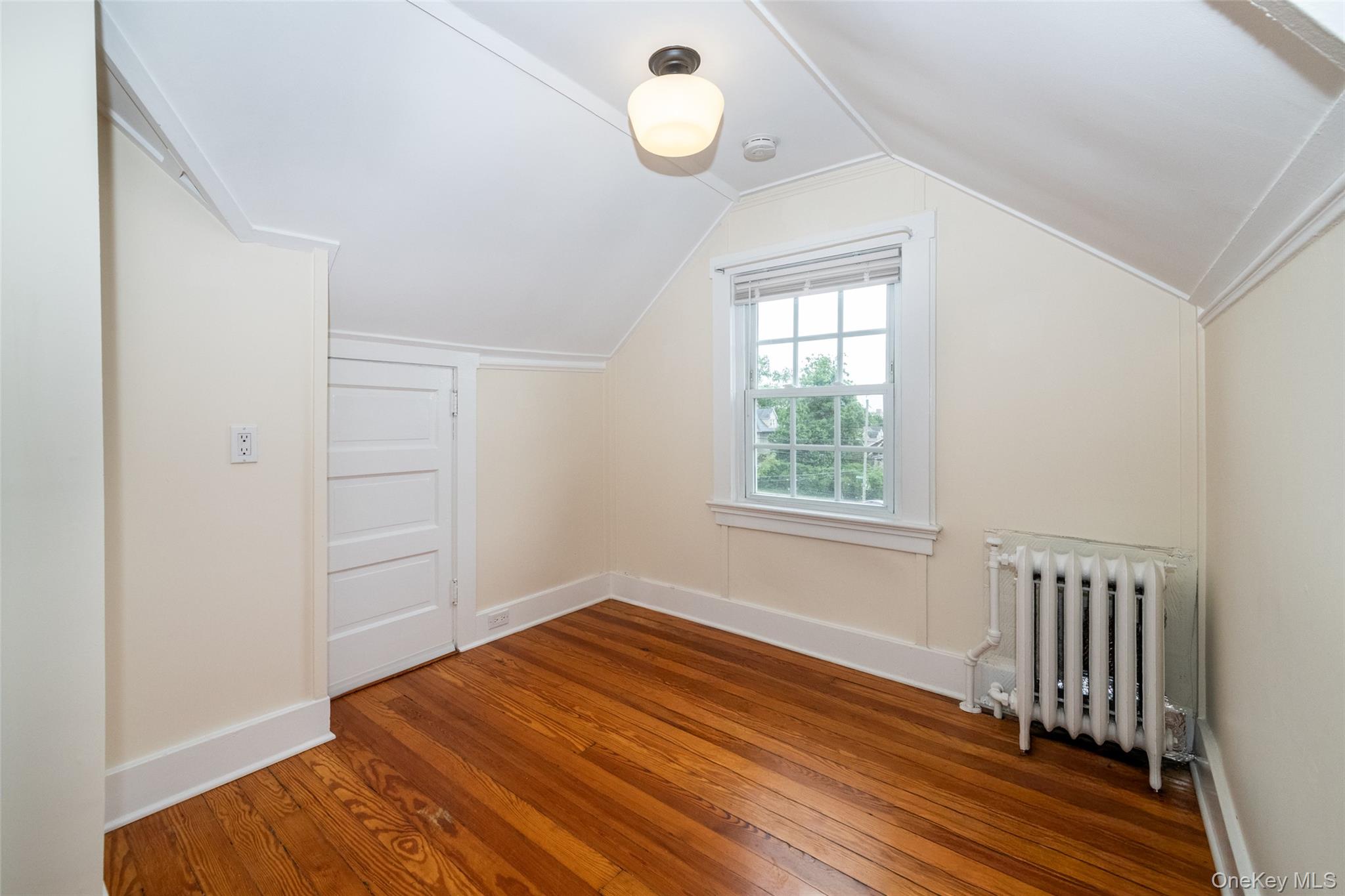82 Clove Road New Rochelle, NY 10801 - Photo 27 of 39 wooden floor in an empty room with a window