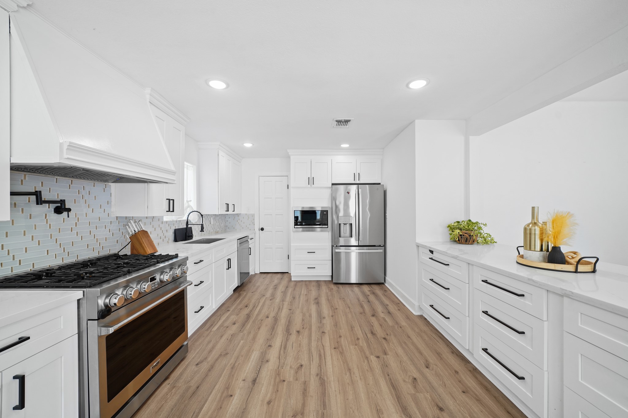 10031 Inwood Drive Houston, TX 77042 - Photo 13 of 31 a kitchen with stainless steel appliances a stove a sink a refrigerator and cabinets