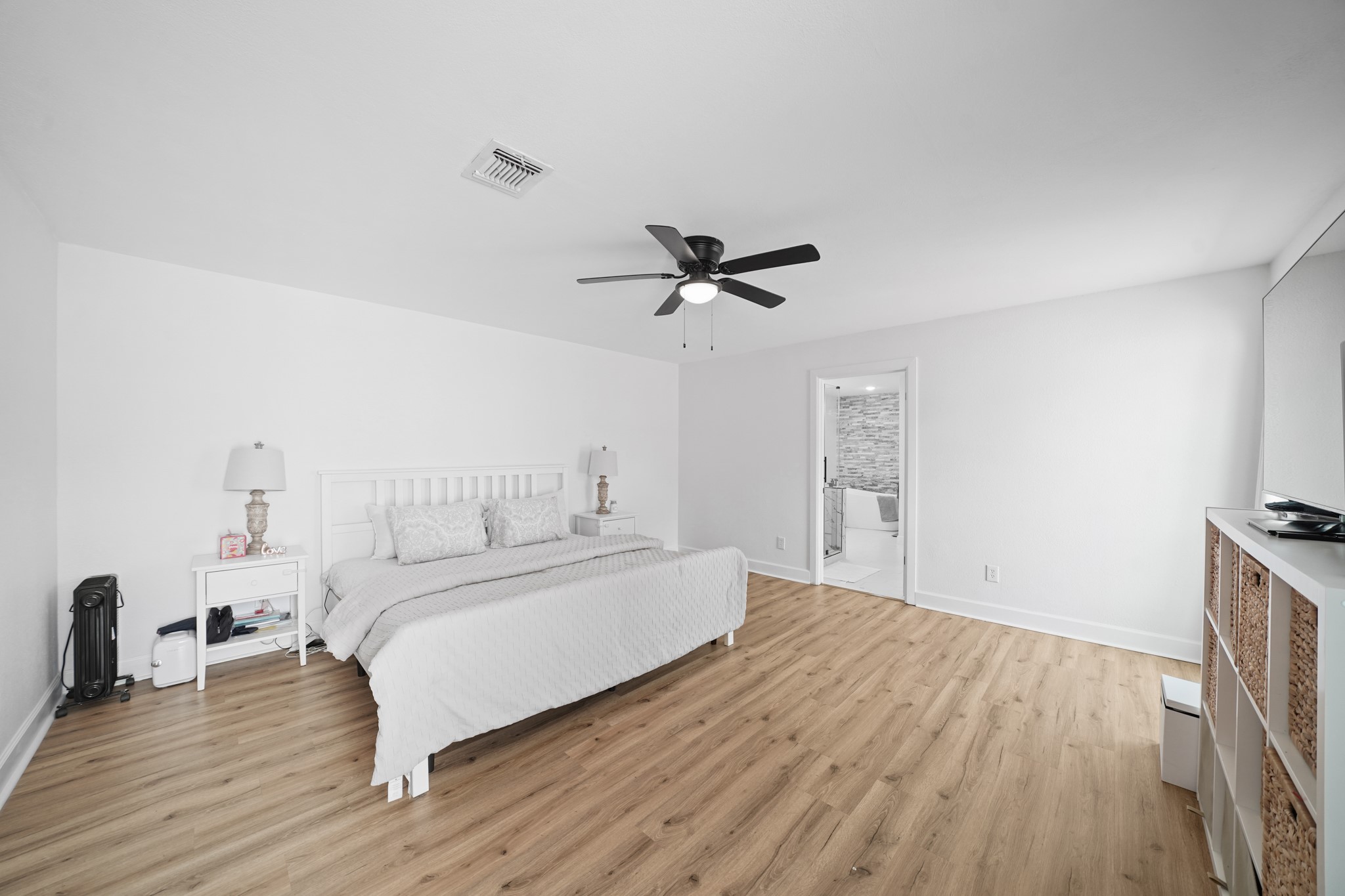 10031 Inwood Drive Houston, TX 77042 - Photo 16 of 31 a bedroom with a bed and wooden floor