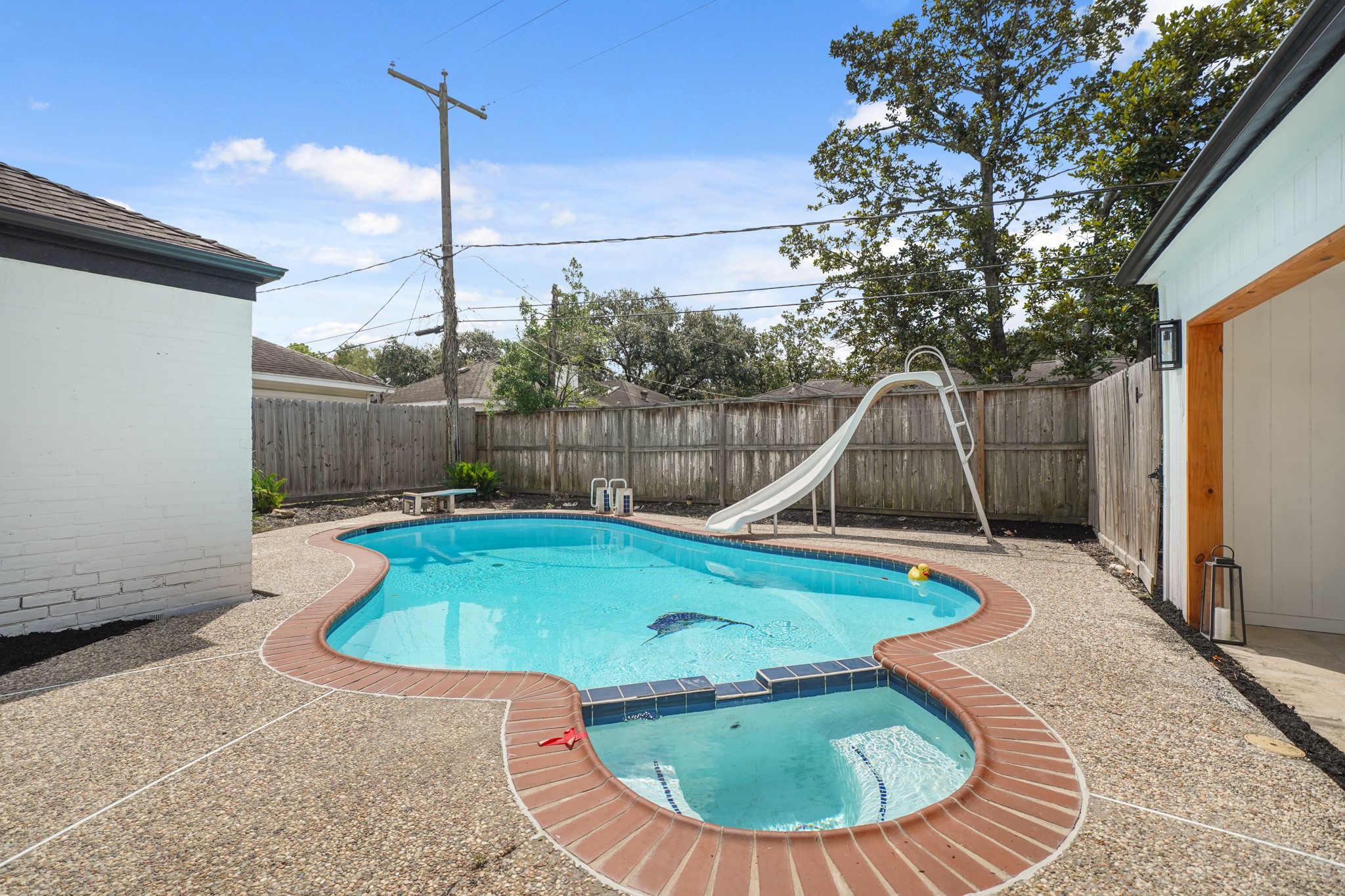 10031 Inwood Drive Houston, TX 77042 - Photo 29 of 31 a view of a swimming pool with a patio