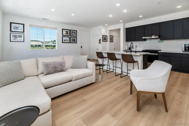 a living room with furniture and kitchen view