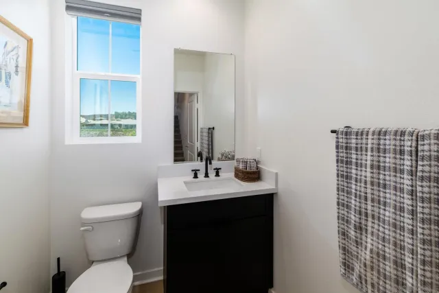 a bathroom with a toilet a sink and a mirror