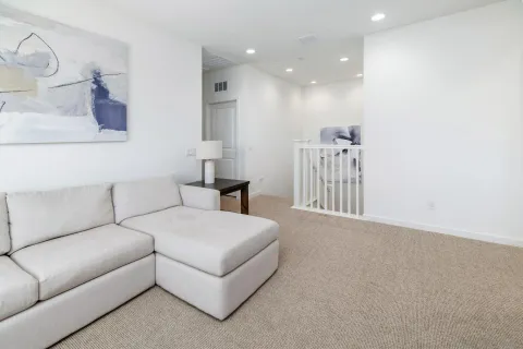 a living room with furniture a mirror and a couch