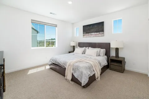 a spacious bedroom with a bed and a window