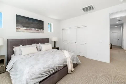 a bedroom with a bed and a wall painting