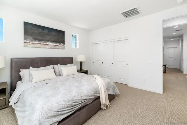 a bedroom with a bed and a wall painting