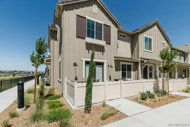 a view of a white building among the house with a fountain