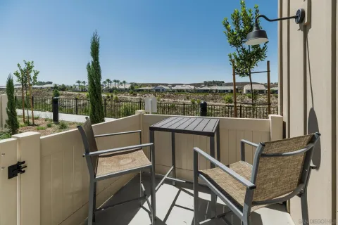 a balcony with table and chairs