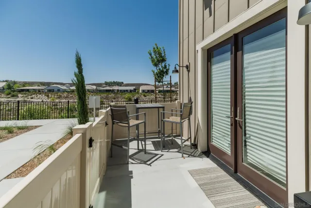 a view of a balcony with chair and wooden floor