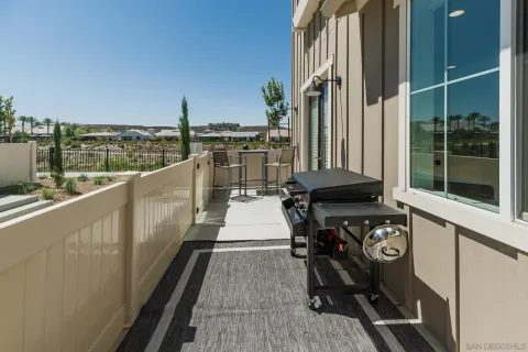 a view of a patio with table and chairs potted plants with wooden floor and fence