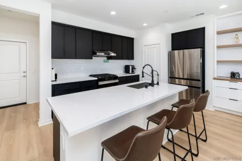 a kitchen with a sink a microwave and cabinets