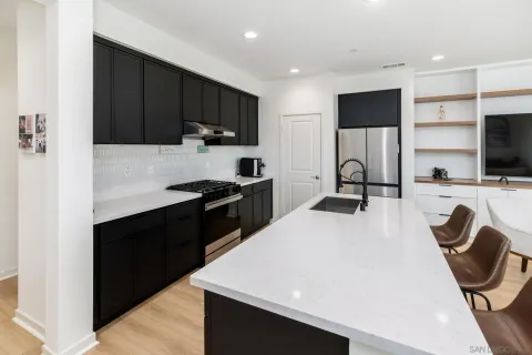 a kitchen with stainless steel appliances a stove sink microwave and cabinets